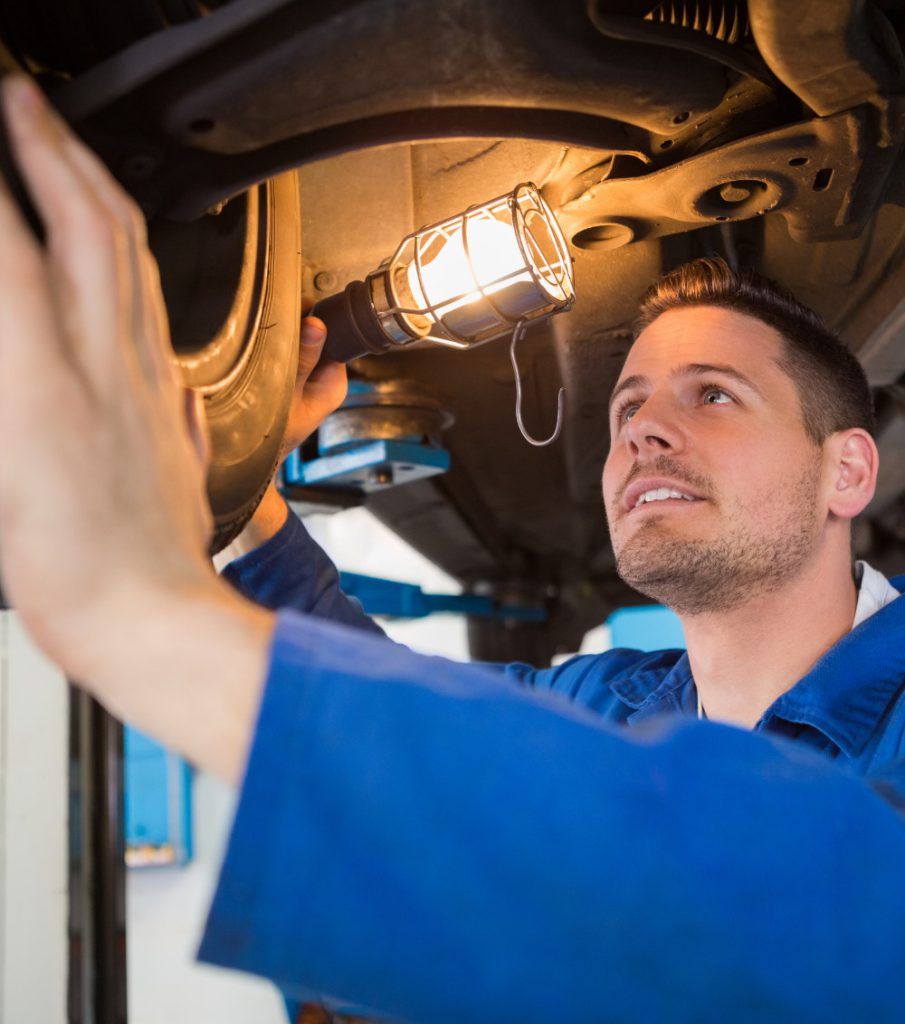 Mechanic inspecting a vehicle for its MOT - MOT Testing Nuneaton