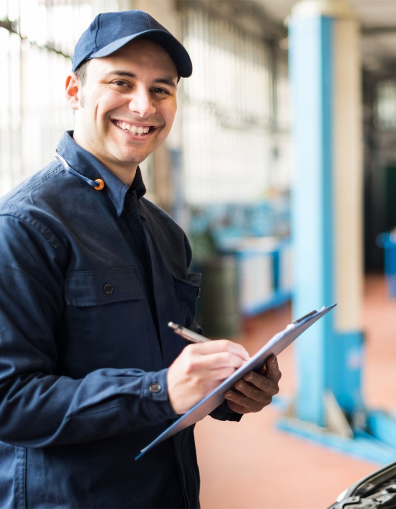 Mechanic checking his inspection sheet - Car Servicing Nuneaton